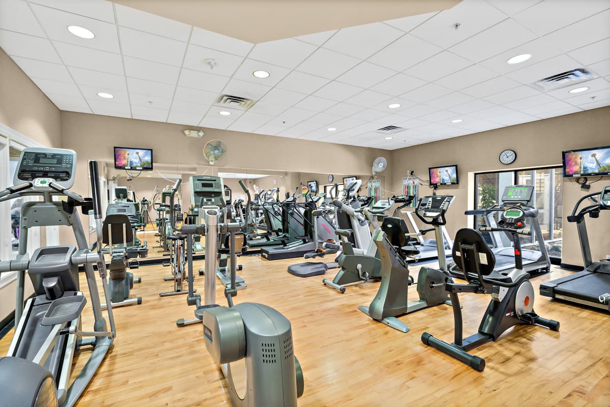 A room of exercise equipment including ellipticals, treadmills and more.
